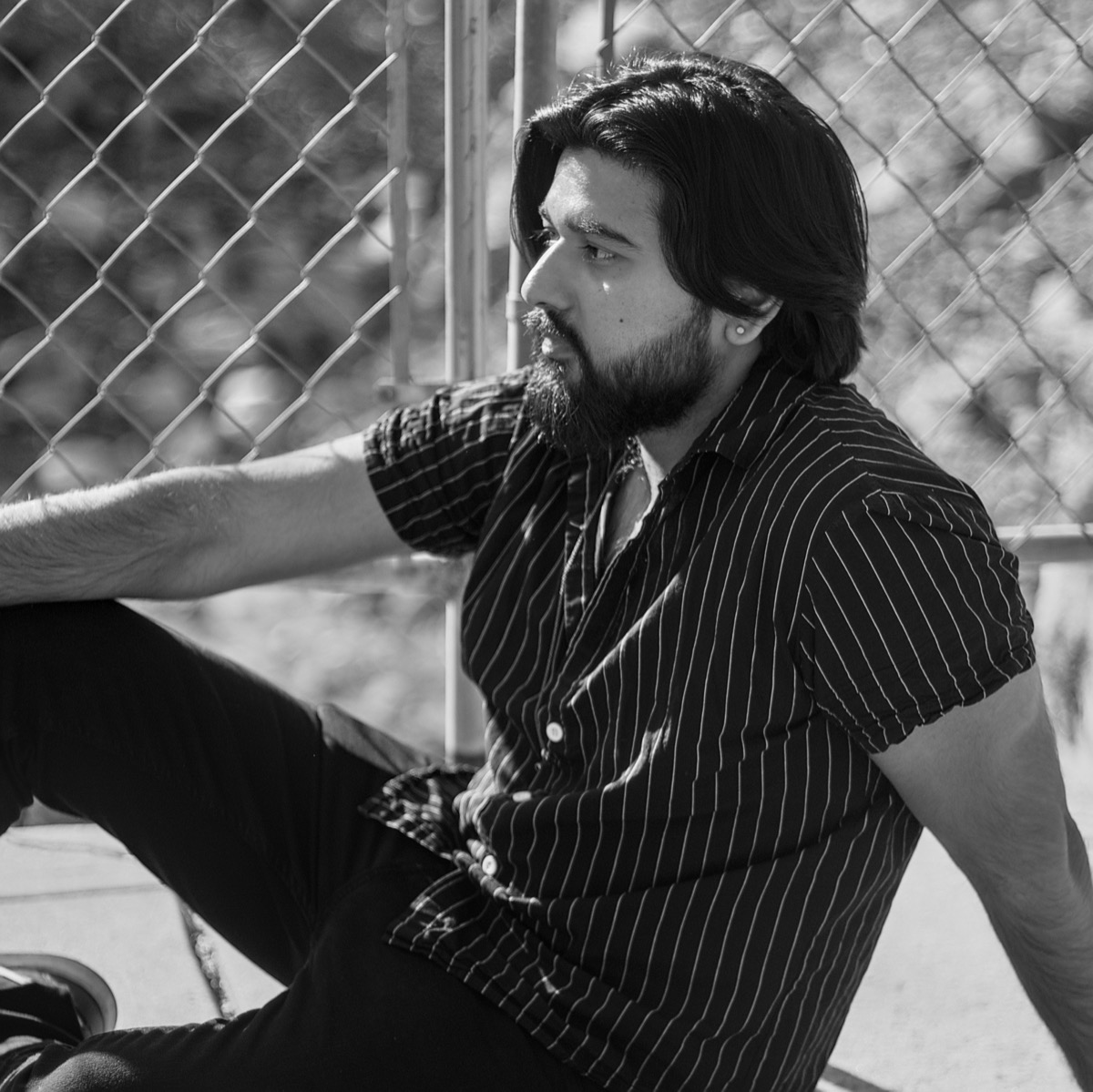 Dee posing while sitting on the floor