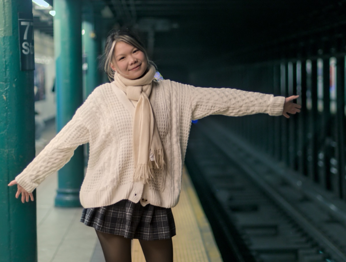 Faye posing in a subway station