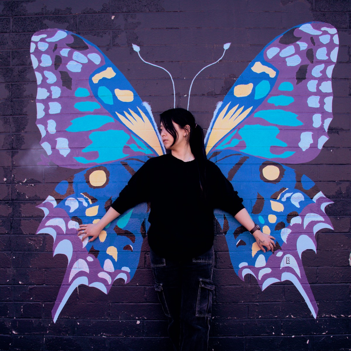 Honey posing in front of a butterfly